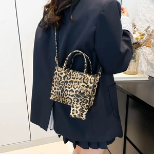 Fashionable leopard print tote bag with mini coin purse shown on model shoulder