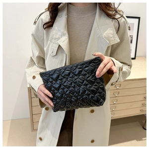 Detail of a chic black cloud pleated handbag with soft quilted nylon fabric and sleek design