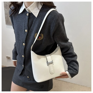 Detailed view of the white crescent shoulder bag with silver buckle and smooth leather