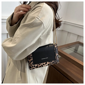 Detail of leopard print crossbody bag with gold chain strap and Fashion & Bags text