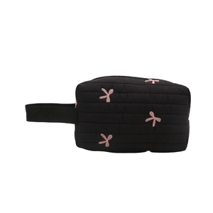 Black quilted makeup bag with pink bow embroidery and sturdy carry handle