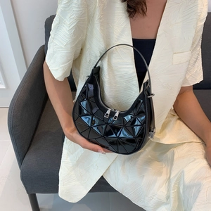 Minimalist black crescent shoulder bag with geometric panel design and glossy finish