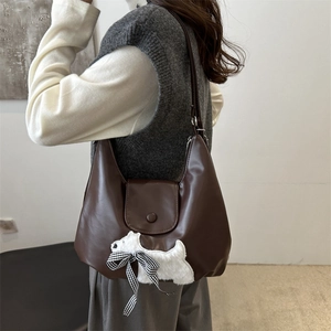 Retro brown faux leather shoulder bag featuring a cute plush dog and plaid bow detail