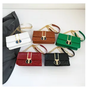 Detail of crocodile embossed crossbody bags with gold metal hardware in five colors