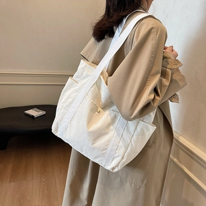 Large off-white corduroy tote bag for women featuring spacious side pockets and soft texture