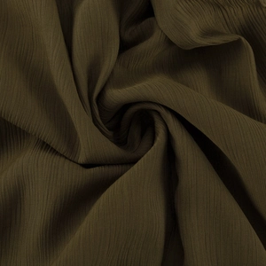 Vue macro détaillée de la texture du tissu plissé vert olive avec un drapé élégant
