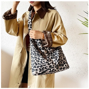 Fashionable leopard print tote bag styled with a trench coat for a casual autumn look
