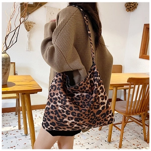 Close-up of large leopard print tote bag in canvas fabric with matching wide strap