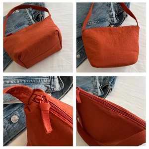 Detail shots of burnt orange hobo bag with zip hardware and pleated fabric texture