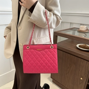 Chic magenta quilted crossbody bag with golden chain strap for stylish women