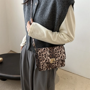 Stylish leopard print crossbody bag with golden buckle shown on a model for autumn fashion