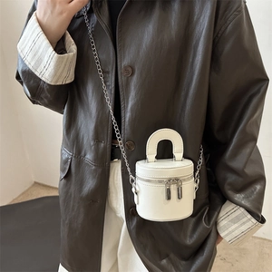 Mini white leather cylindrical bucket bag with silver chain strap and dual zippers