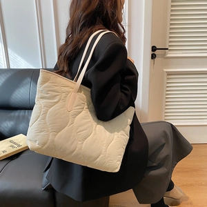 Quilted beige puffer tote bag with wave pattern for casual daily commute wear