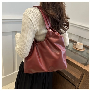 Close-up of oversized burgundy tote bag in soft leather material for daily commute