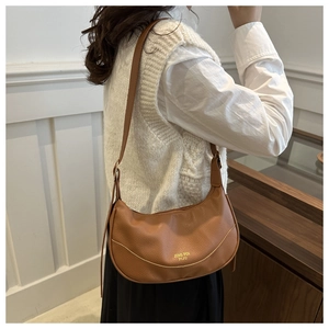 Brown lychee leather crescent bag shown on model for daily casual shoulder wear style