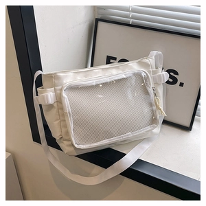 Close-up of white canvas crossbody bag featuring a clear PVC window and adjustable buckle