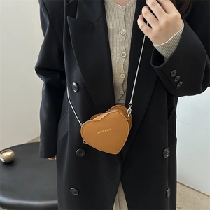 Brown heart-shaped mini leather crossbody bag with elegant silver chain strap