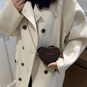 Minimalist heart-shaped crossbody bag in chocolate brown faux leather with chain strap