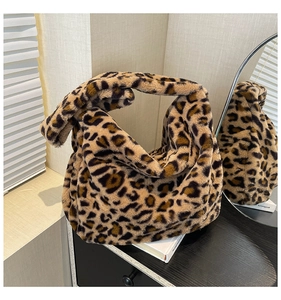 Detail of faux fur shoulder bag with trendy leopard print and soft plush winter texture