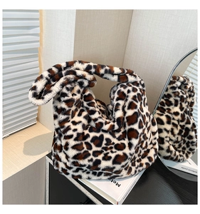 Detail of trendy leopard print plush tote bag with soft texture and shoulder strap design