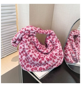 Detail of pink leopard plush tote bag featuring a creative knotted handle design