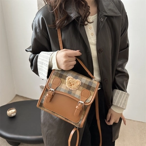 British style plaid crossbody bag with bear patch and leather trim shown with a model