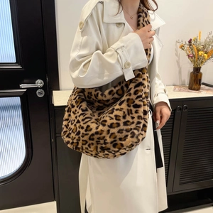 Fashionable oversized leopard print plush shoulder bag styled with a white coat