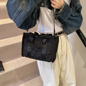 Chic black quilted tote bag with large capacity and adjustable strap for daily commute
