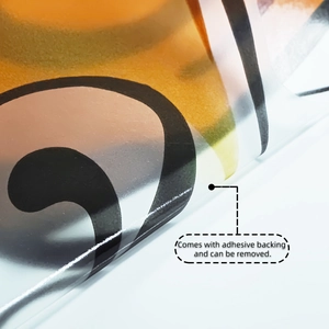 Self-adhesive coffee cup wall sticker being peeled, showing black swirl pattern detail