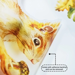 Detail of adhesive backing on squirrel and acorn wall sticker for easy removal