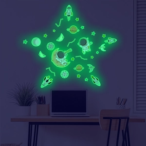 Luminous space wall stickers showing astronauts and planets glowing green in the dark