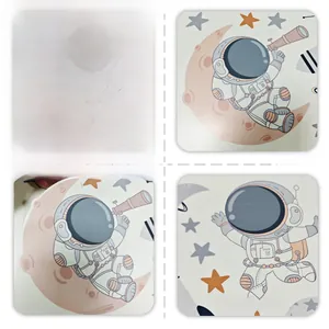 Detailed view of luminous astronaut wall stickers with telescope and moon patterns