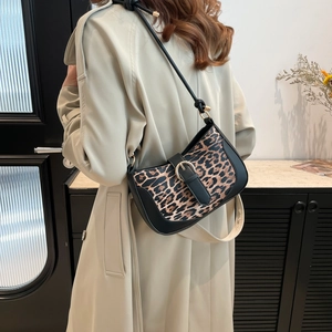 Vintage leopard print underarm bag with black trim and sleek metallic buckle detail