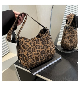 Detailed view of leopard print hobo bag with soft velvet texture and gold hardware