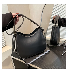 Detailed close-up of premium black PU leather bag with gold-toned zipper and hardware