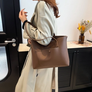 Large brown synthetic leather tote bag with functional front pocket for daily commuting