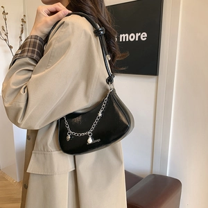 Fashionable black baguette bag with silver chain and heart pearl pendant detail