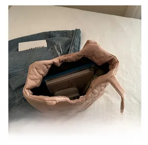 Internal view of a light pink heart-quilted tote bag showing its large storage capacity
