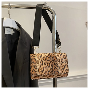 Close-up of leopard print shoulder bag with fuzzy texture and black nylon strap