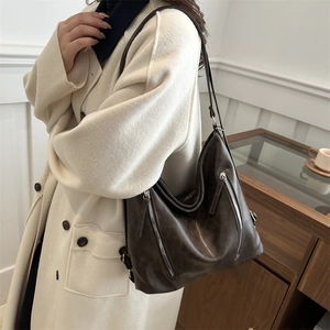 Deep brown retro leather tote bag for women showing a stylish slouchy silhouette on model