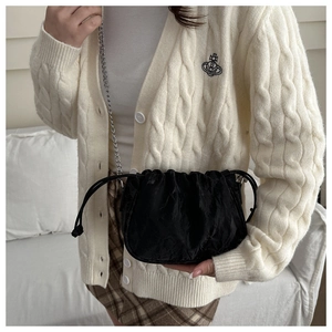 Detail of black pleated cloud bag with silver chain strap and drawstring closure