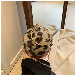 Detail of leopard print ball bag with rhinestone metal handles and golden chain strap