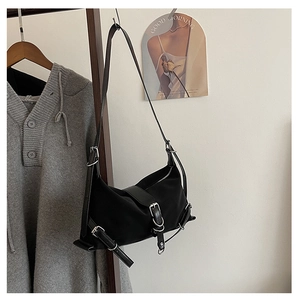 Detail of black nylon hobo bag featuring silver buckles and adjustable shoulder straps