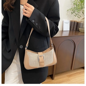 Détail du sac croissant en toile avec bordure en cuir et boucle argentée décorative