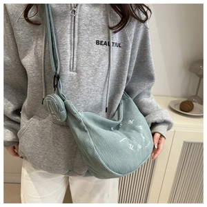 Detail of green corduroy hobo bag with letter print and detachable mini round coin purse