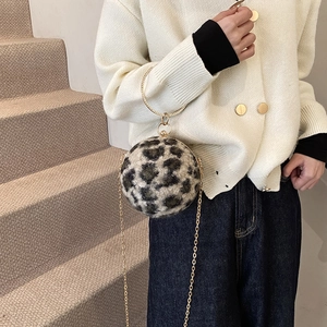 Spherical leopard print plush handbag with golden circular handle and chain strap for women