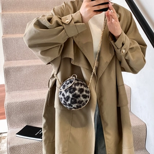 Spherical leopard print mini bag with gold chain and round handle on female model