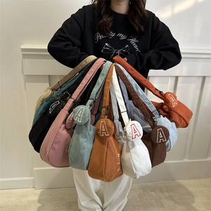 Chic corduroy crossbody dumpling bag with mini round pouch and adjustable strap in various colors