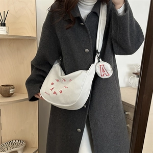 White corduroy crescent shoulder bag with red embroidery and matching round coin purse