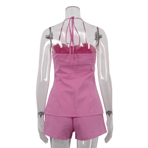 Rear view of a pink two-piece set featuring a halter tie-back top and casual shorts
